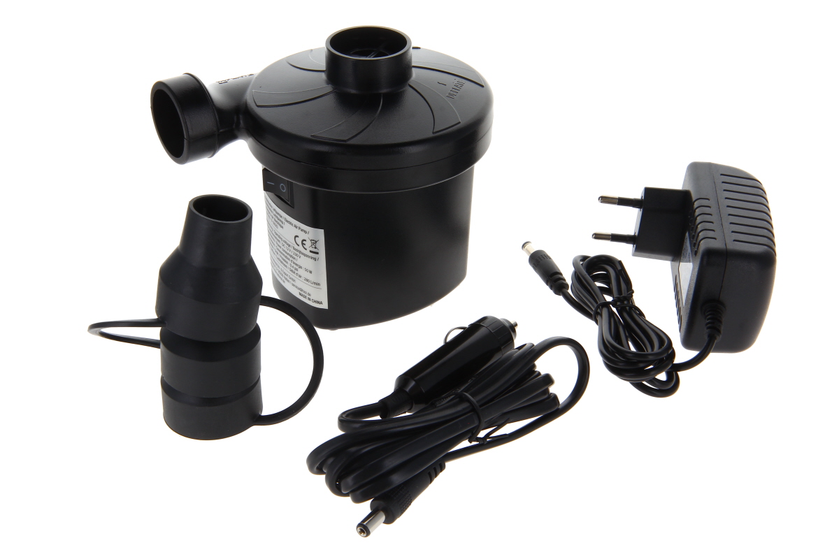Black electric air pump with on/off switch, round inlet and outlet. Includes a black nozzle attachment, coiled power cable with car adapter (cigarette lighter) and a separate mains adaptor with cable. Shown against a light-coloured background.