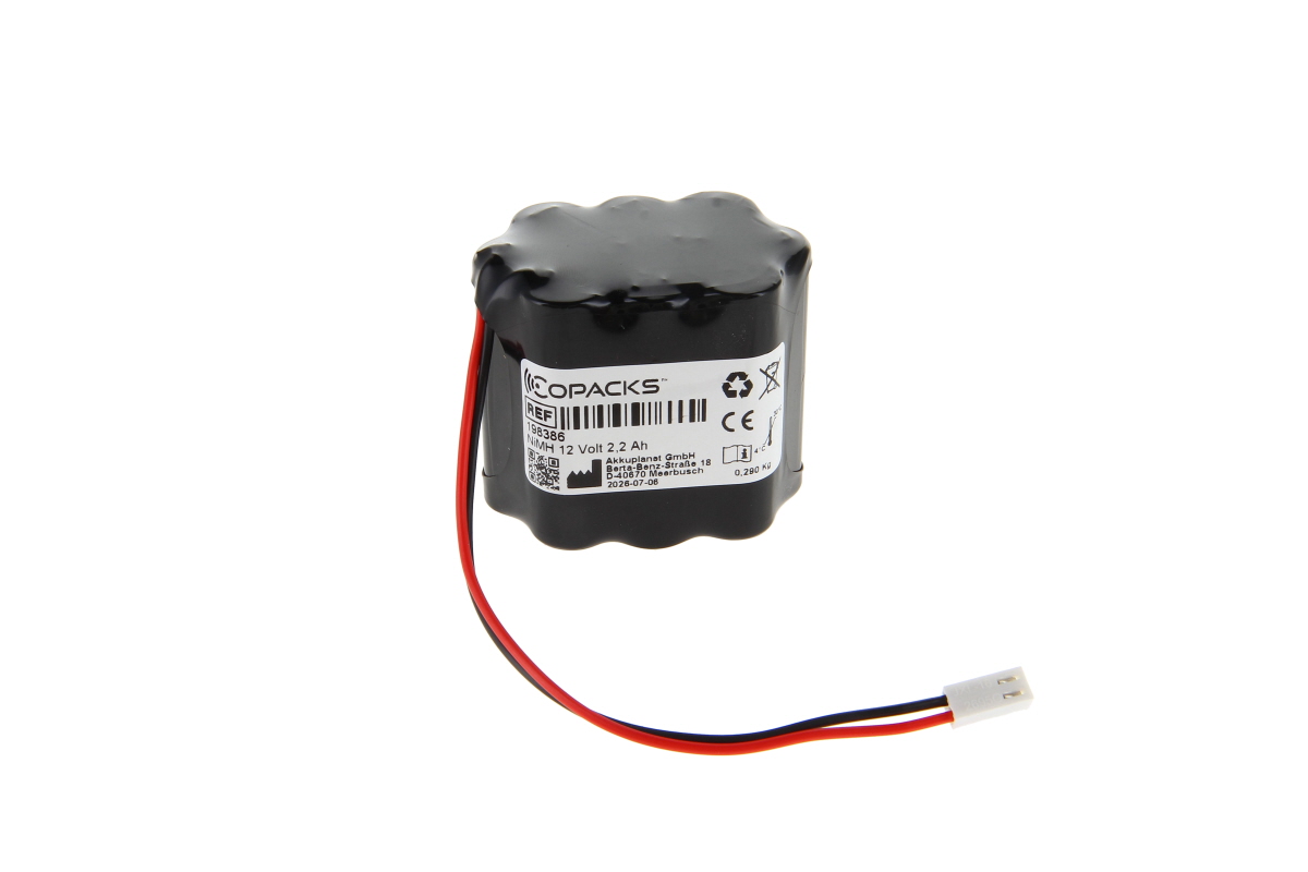 Black battery pack comprising cylindrical cells with an uneven, glossy surface. White label on the side bearing ‘COPACKS’, ‘NiMH 12 Volt 2.2 Ah’ and manufacturer’s details. Red and black cables connected to a white 2-pin plug.