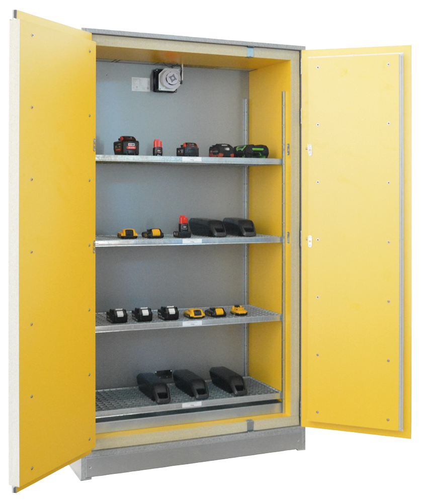 An open battery safety storage cabinet with yellow doors and a grey interior. Four wire-mesh storage shelves are filled with Li-ion batteries from various manufacturers. A ventilation system is visible at the top.
