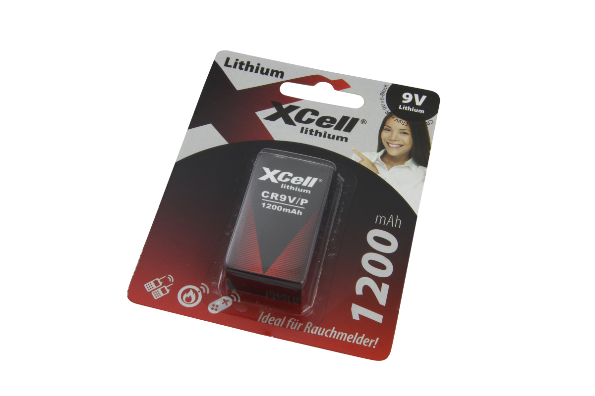 XCell Litium 9,0V E-block-batteri i förseglad blisterförpackning, perfekt för brandvarnare. Svart batteri med rött tryck: XCell, CR9V/P, 1200mAh. Röd, svart och vit förpackning med kvinno- och applikationssymboler.
