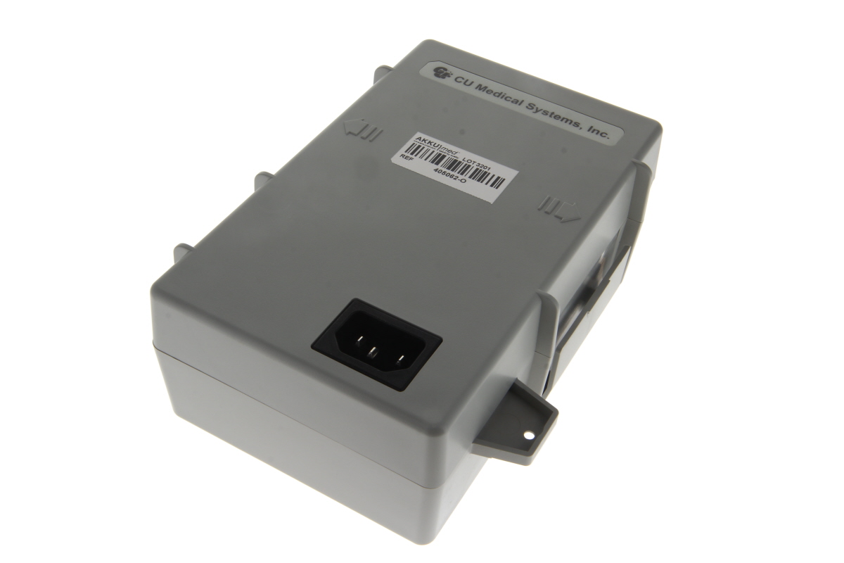 A grey, rectangular ‘ CU Medical ’ EU power supply with a black three-pin mains plug. On the top is the ‘CU Medical Systems, Inc.’ logo and a label reading ‘AKKUmed ’ along with the reference number 405082-O. Mounting tabs are visible on the sides.