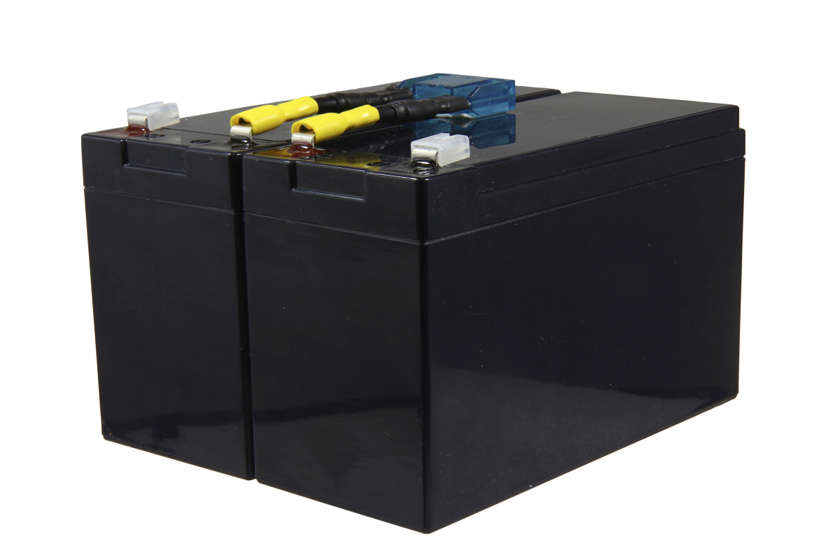Two black, rectangular replacement batteries are positioned side by side and connected by a cable. At the top are yellow, insulated cable lugs leading to a blue, transparent fuse holder. Part of a replacement battery set for the APC RBC9.