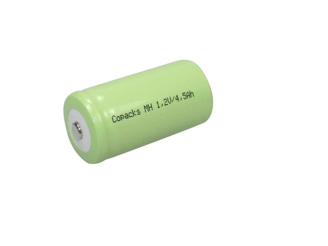 A light green NiMH Baby C battery lies diagonally on a white background, from bottom left to top right. The side reads ‘Copacks MH 1.2V/4.5Ah’ in black. The raised silver positive terminal is visible.
