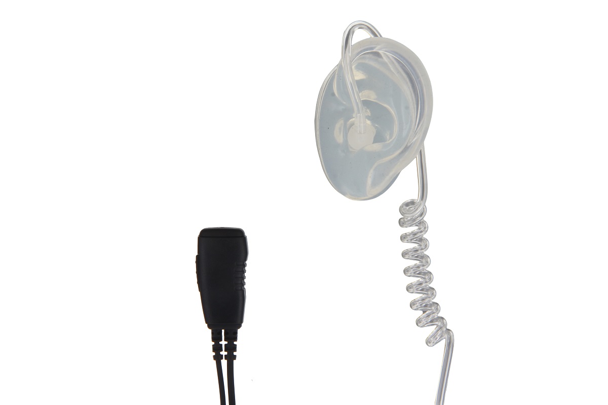 Transparent acoustic tube headset with a clear, ear-shaped earpiece for discreet wear. Connected to a compact black microphone/PTT unit with two connection cables at the bottom. CoPacks, compatible with Yaesu/Vertex two-way radios.