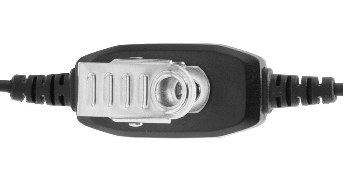 Detailed view of a black PTT unit for an CoPacks headset, compatible with radios such as the Motorola SL models. The housing is oblong, with a silver metal clip for attaching to clothing. Cables emerge from the left and right sides.