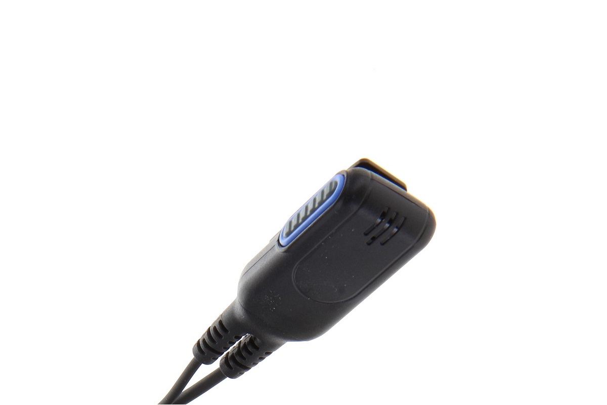 Close-up of a black, waterproof Push-to-Talk (PTT) button from the CoPacks headset, tilted slightly upwards to the side. Oval shape with a blue outline around the activation button, two connection cables at the bottom, and grooves on the sides.