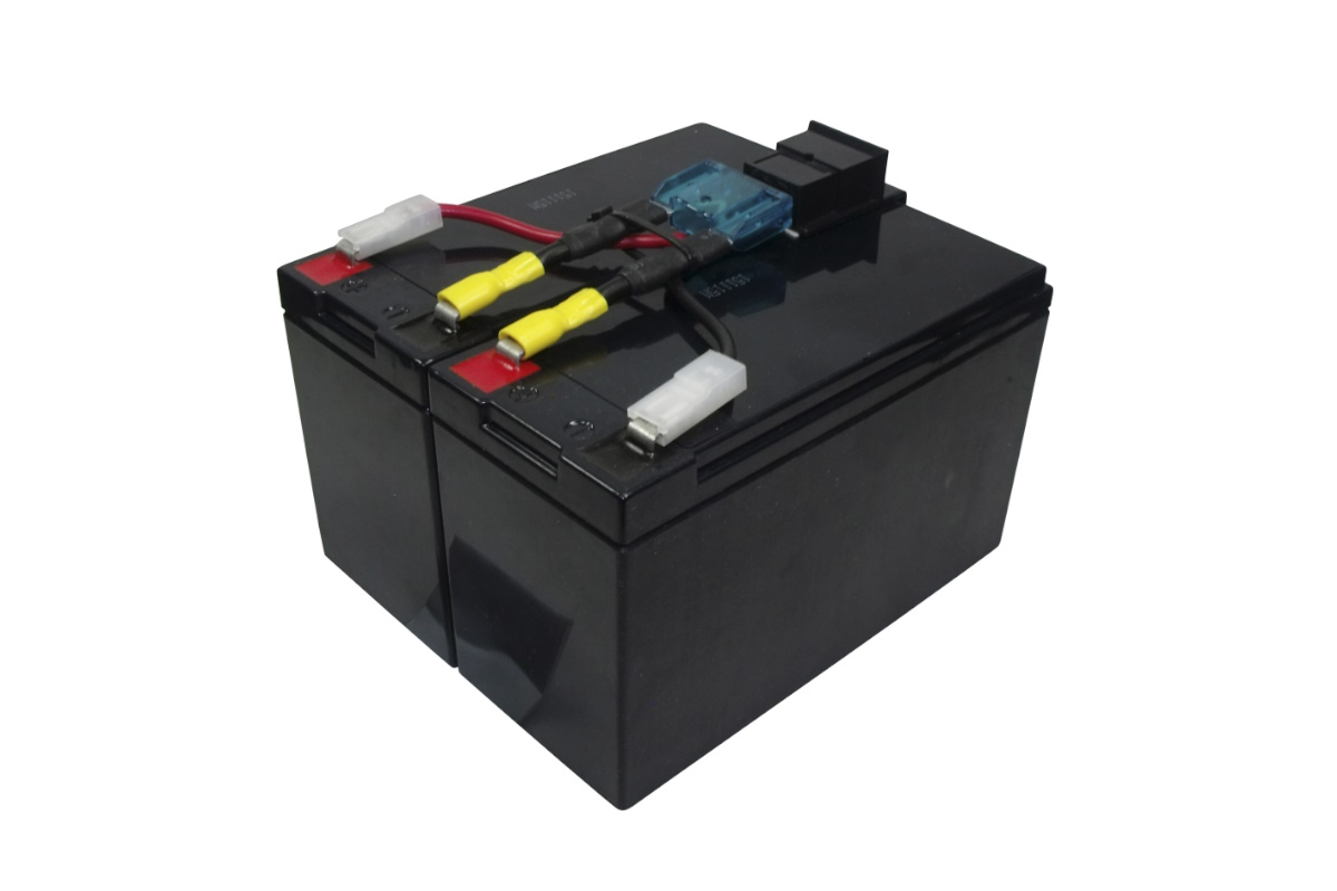 Two black, rectangular battery modules side by side, connected by red and black cables with yellow spade connectors. Visible: a blue fuse holder with a fuse and a white connector. Replacement batteries for the APC RBC48 UPS.