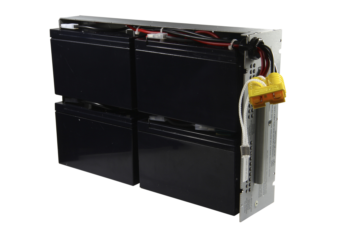 Compact replacement battery for APC systems, comprising four black, rectangular battery cells in a metal frame. Red and black cables connect the cells. On the right is a yellow connector with a white retaining loop attached to a metal plate.