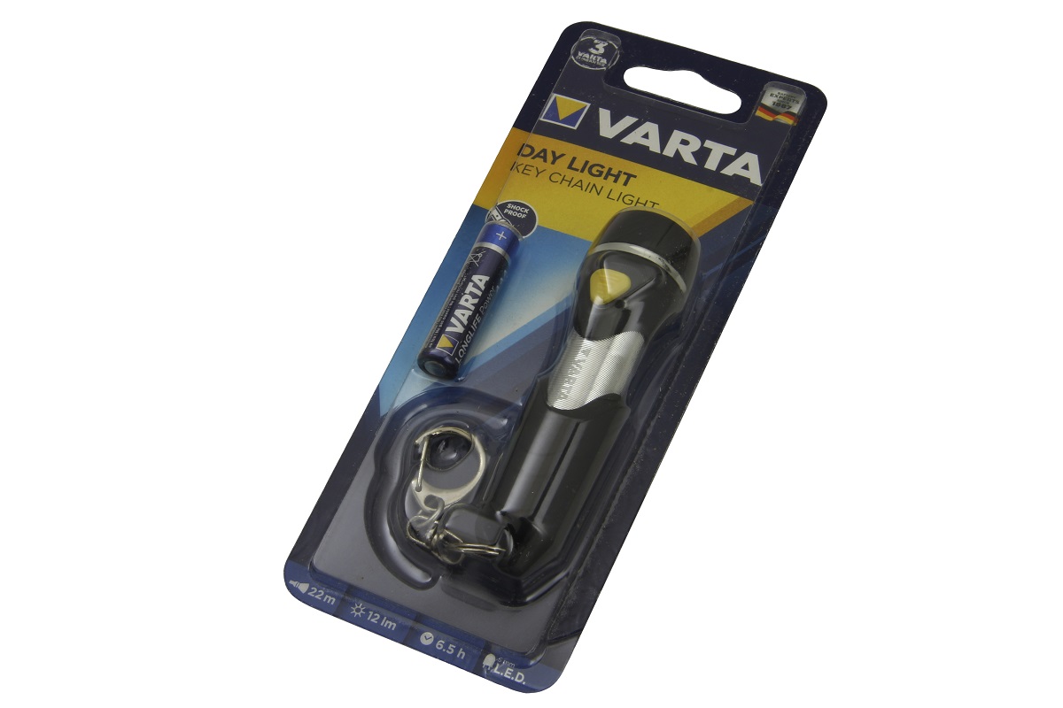 Varta Day Light keyring torch with a ‘ Varta ’ AAA battery, in its original transparent blister pack. Black torch with silver detailing and a yellow power button, featuring a keyring at the bottom. Product information visible.