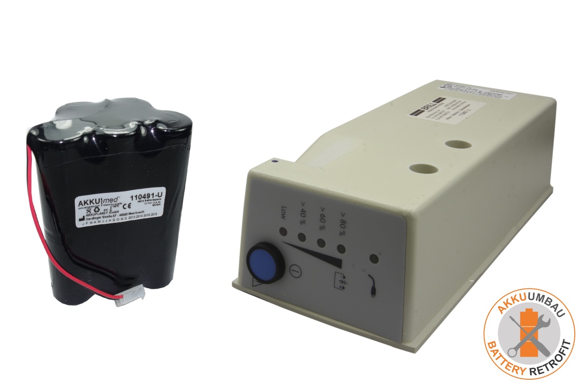 Black cylindrical 'AKKUmed' battery pack with red cables and white plug beside beige rectangular housing of an 'Atmos' Atmoport N suction pump. Control unit with blue button and display showing 'LOW' to '>80%'. Logo and model 110491-U visible.