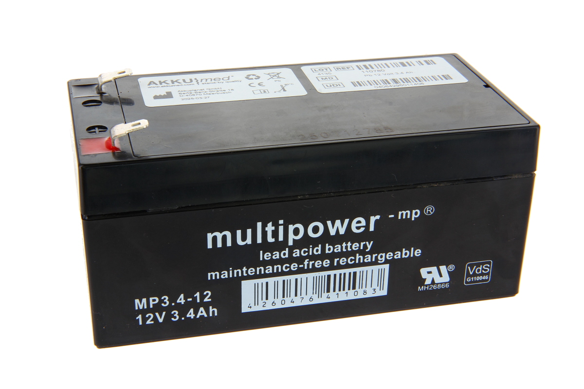 Black rectangular lead-acid battery ‘ AKKUmed ’ Multipower -mp® MP3.4-12 (12V 3.4Ah) with two silver flat plugs at the top, the right-hand one marked in red. Label with technical data/barcodes. Replacement battery for, e.g., Dräger ventilators.