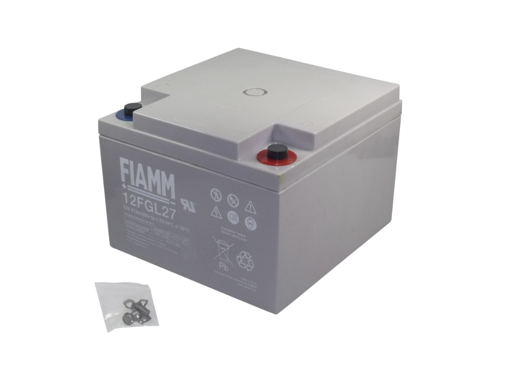 Grey, rectangular FIAMM AGM battery 12FGL27 with two terminals on top (blue negative, red positive). The front shows the brand, model and specifications such as ‘12V 27Ah’. Next to it is a bag containing installation materials.