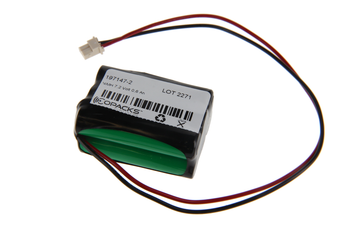 Batería NiMH negra con la parte inferior verde y etiqueta blanca («COPACKS », «NiMH 7,2 voltios 0,6 Ah», «197147-2»). Dos cables rojos/negros conducen a un conector blanco. Para iluminación de emergencia y de seguridad.