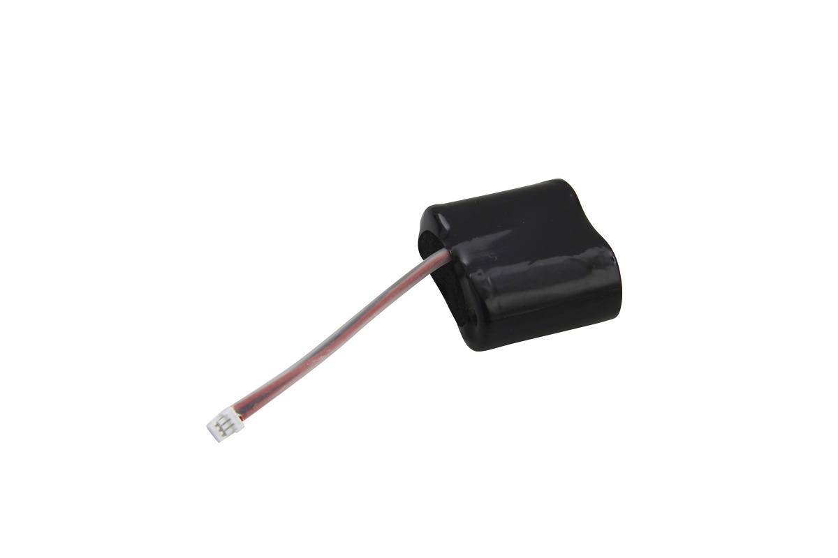 A black, rectangular lithium battery, shrink-wrapped, with a short red and grey cable ending in a small white plug. The battery is compatible with electronic DOM ELS Pro locking cylinders and provides 2 x 3 volts.
